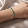 Emerald green crystal bracelet on model's wrist