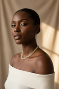 Black model wearing golden citrine crystal chip necklace and earring set