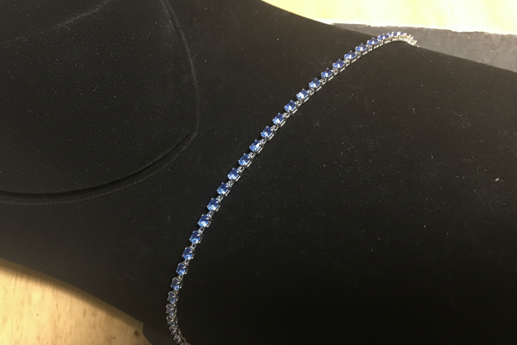 7 inch rhodium blue crystal tennis bracelet on dark velvet display