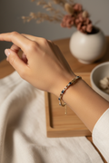 14K gold sapphire and crystal tennis bracelet worn on a model's wrist