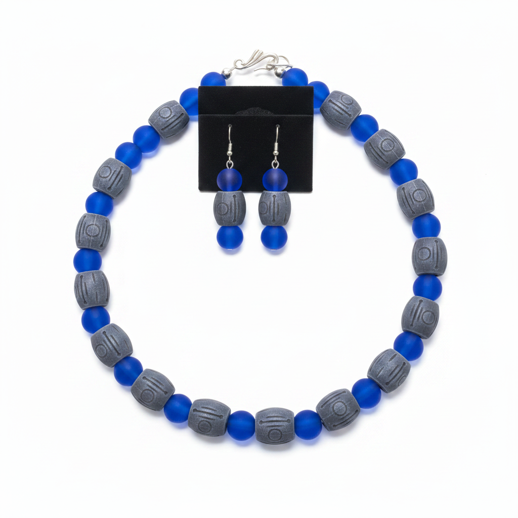 Blue sea glass and carved gray barrel necklace set on white background