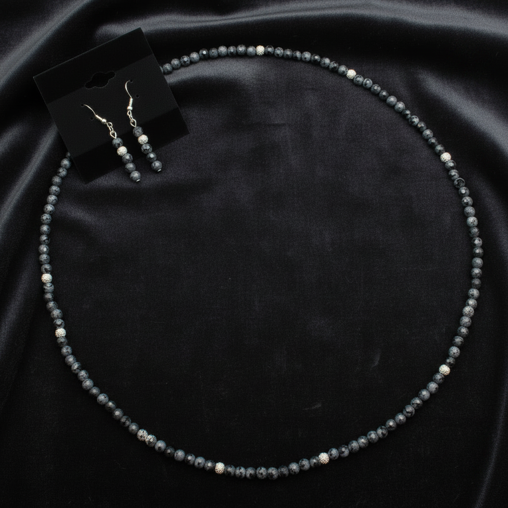 Dalmatian jasper and silver necklace and earring set on white background