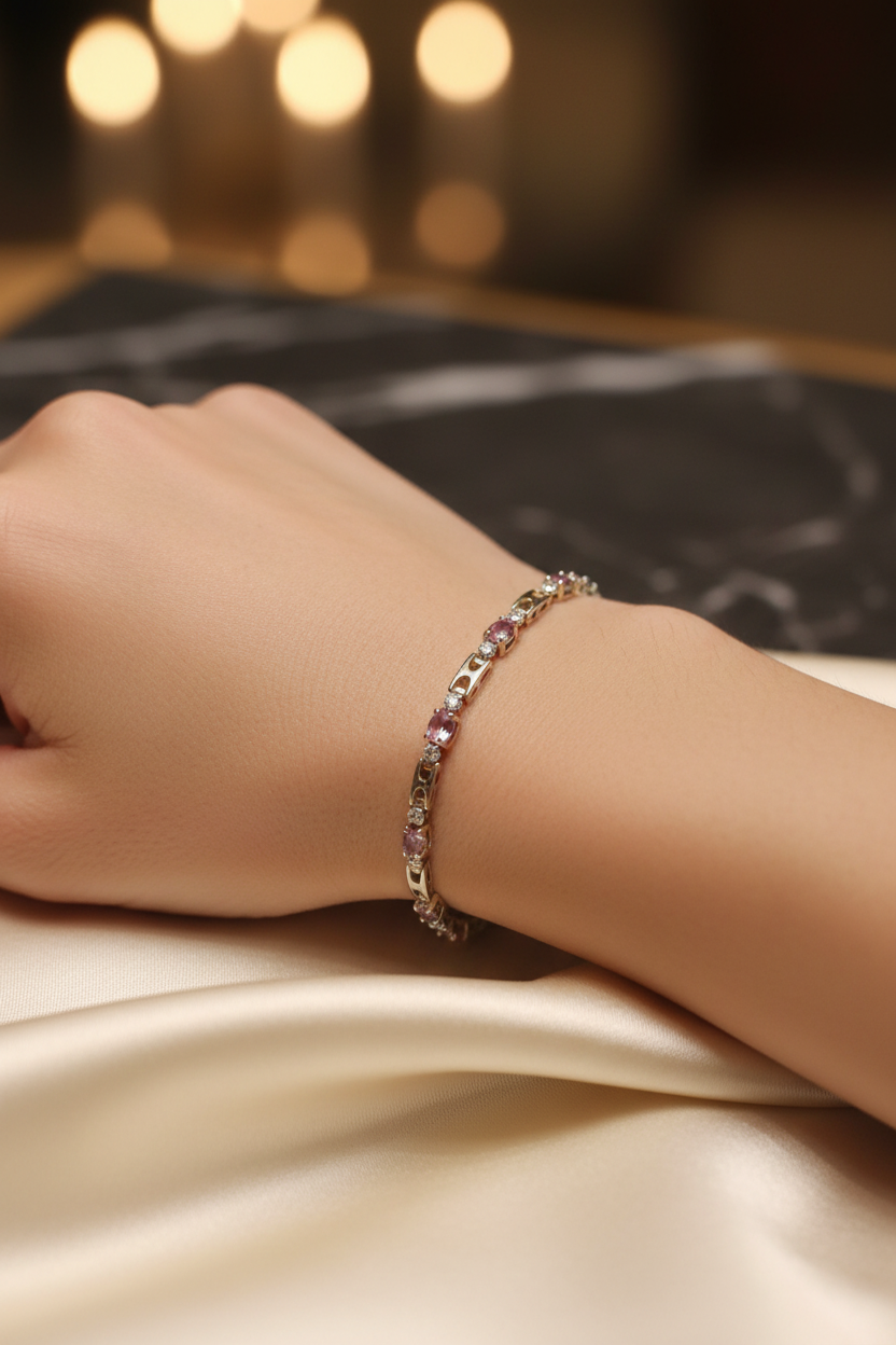 14K gold plated pink amethyst and crystal tennis bracelet worn on a model's wrist