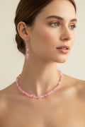 Pink and clear daisy bead necklace and earring set on black velvet display