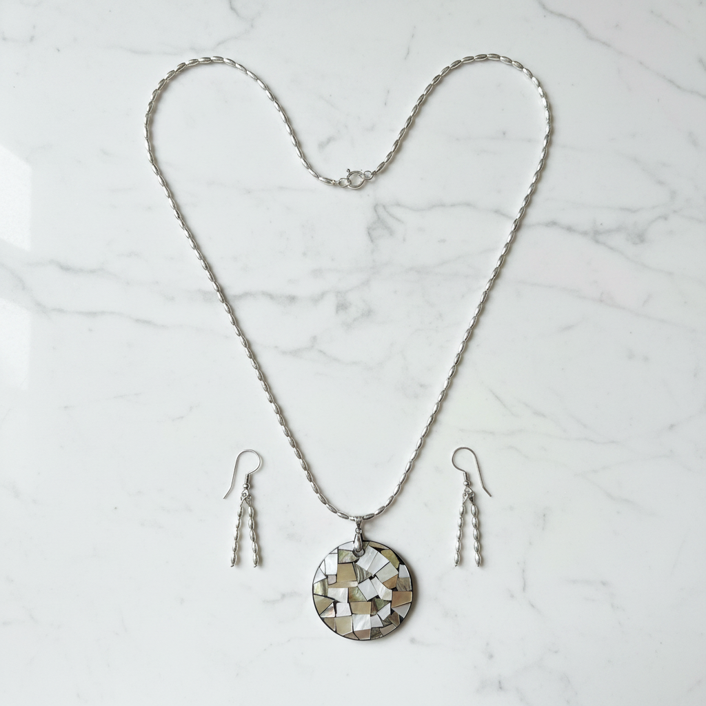 Silver oval bead necklace with mosaic shell pendant on white marble