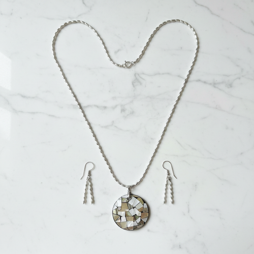 Silver oval bead necklace with mosaic shell pendant on white marble