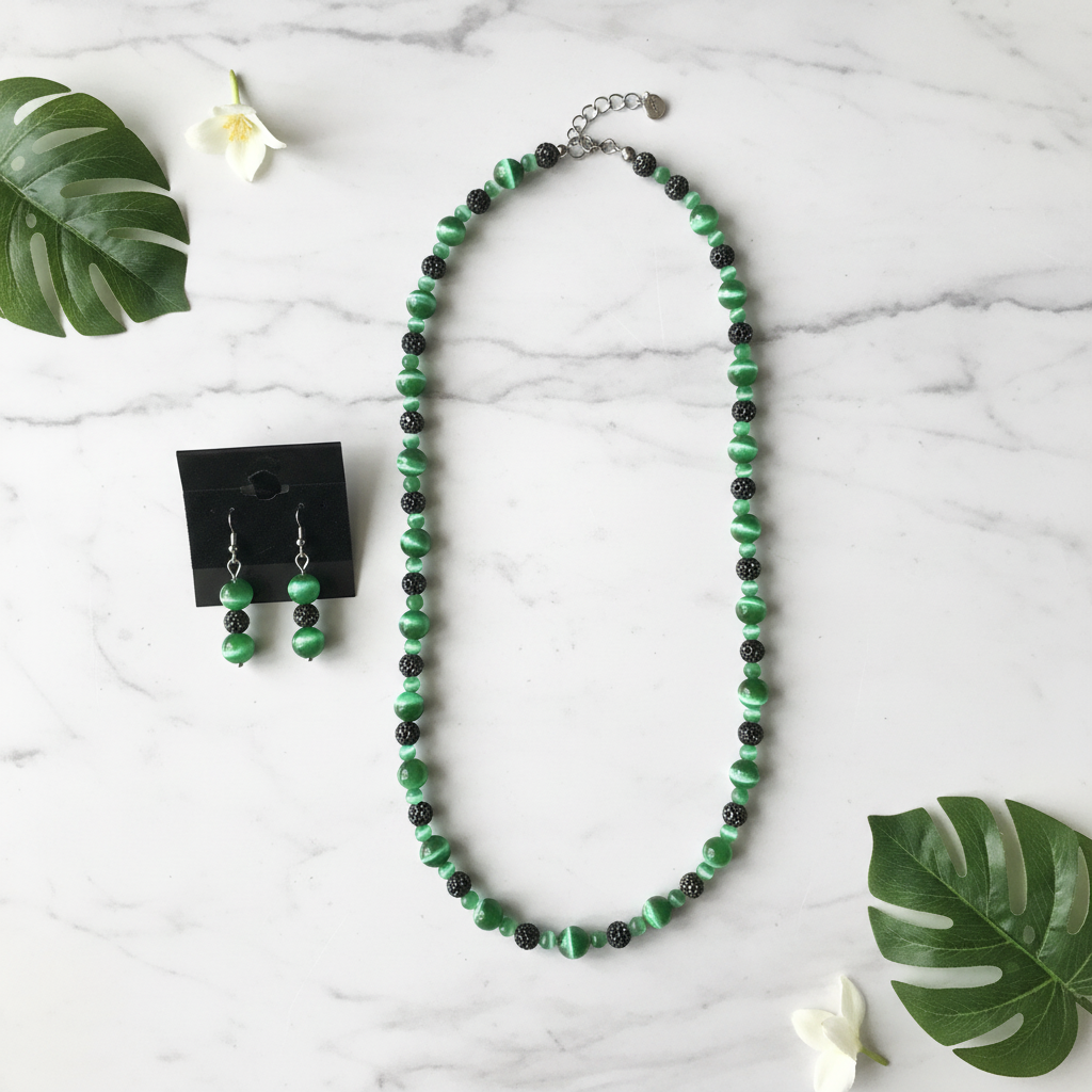 Green cat's eye necklace flat lay on white marble