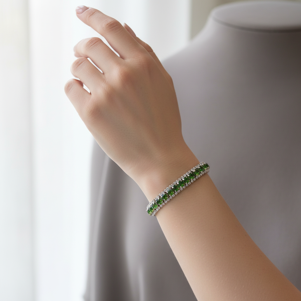 Green crystal tennis bracelet worn on model wrist