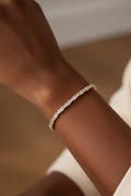 Dark-skinned model wearing 7.5 inch large crystal 14K gold plated tennis bracelet