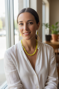 Model wearing yellow cube cat's eye bead necklace and earrings