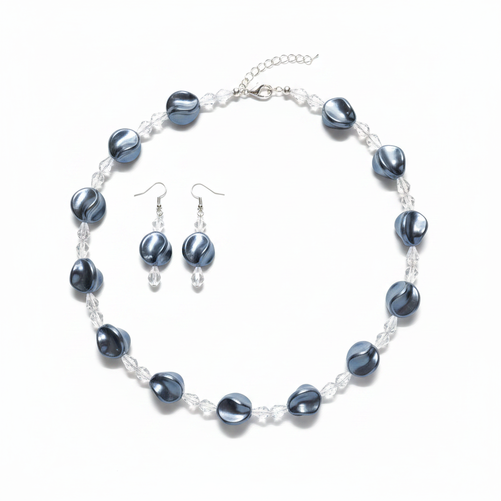 Dark blue-grey coin pearl and crystal necklace and earring set on white background