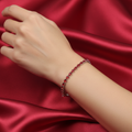 Red crystal tennis bracelet worn on model's wrist