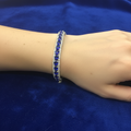 Sapphire blue crystal bracelet on model wrist with royal blue velvet background