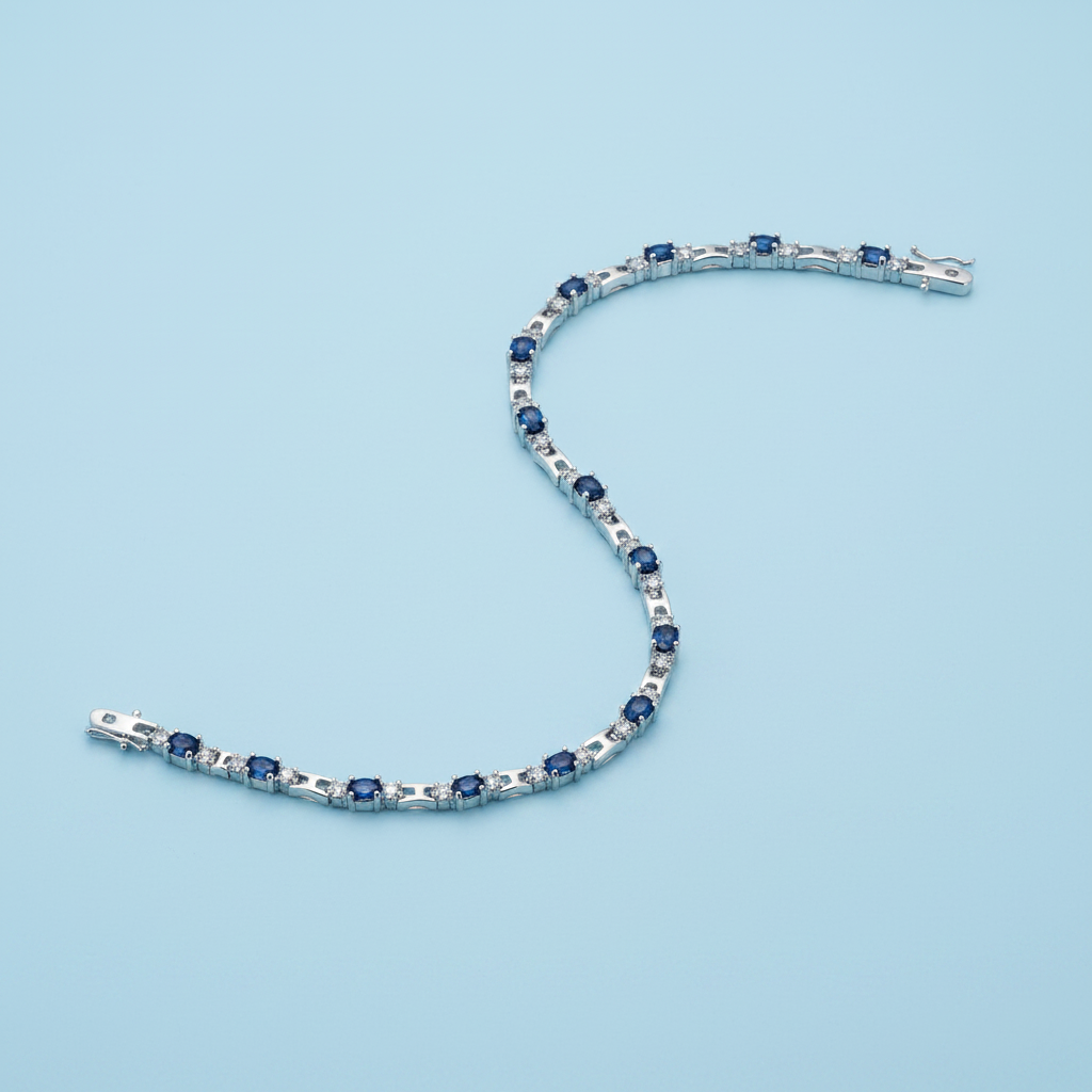 Rhodium sapphire and crystal tennis bracelet on light blue background