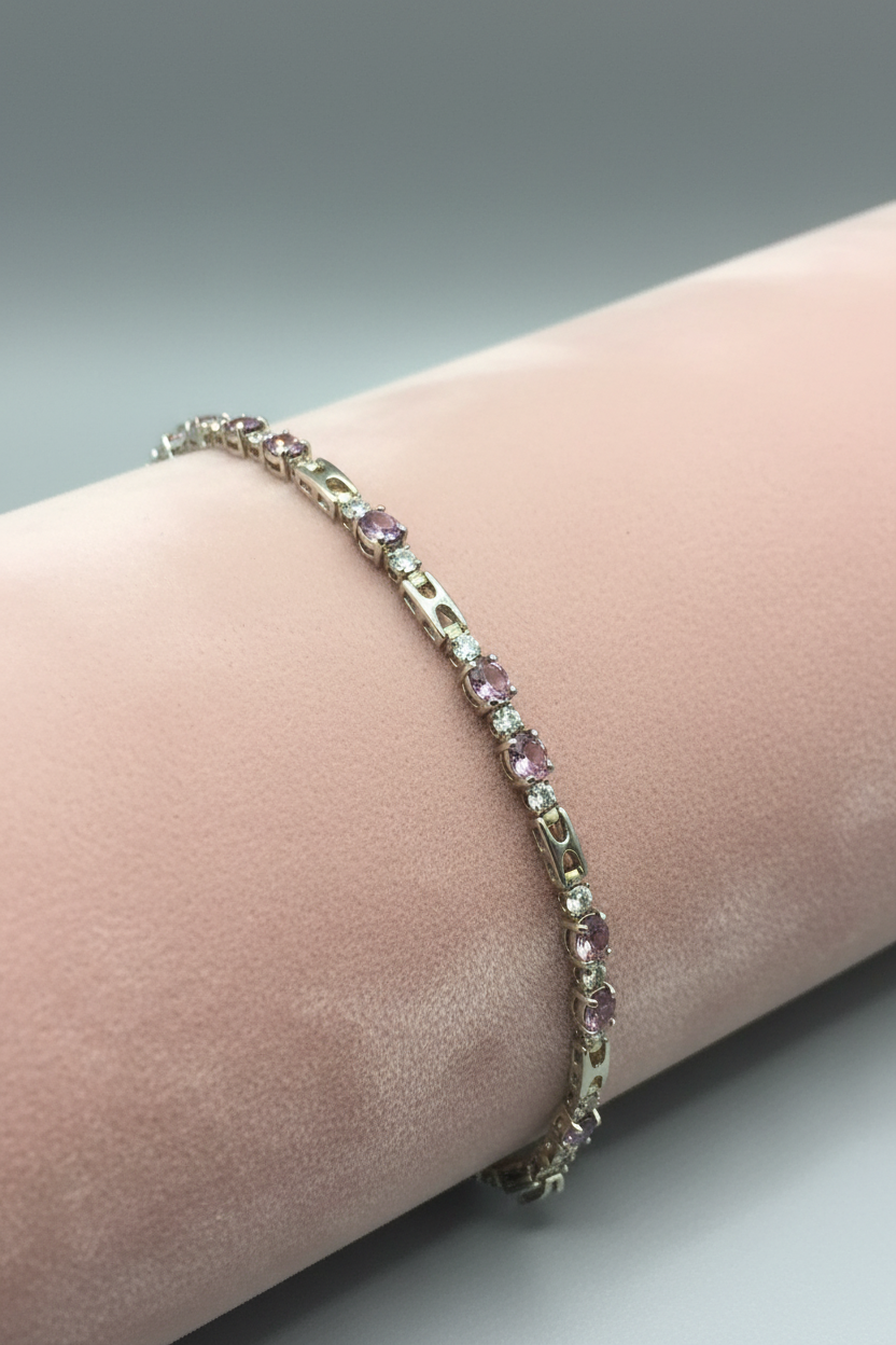 14K gold plated pink amethyst and crystal tennis bracelet on blush velvet ramp display