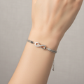 Infinity bracelet on model showing crystal charm detail
