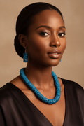 Model wearing blue carved coconut bead necklace and earrings