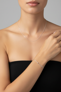 Model wearing silver necklace and bracelet set